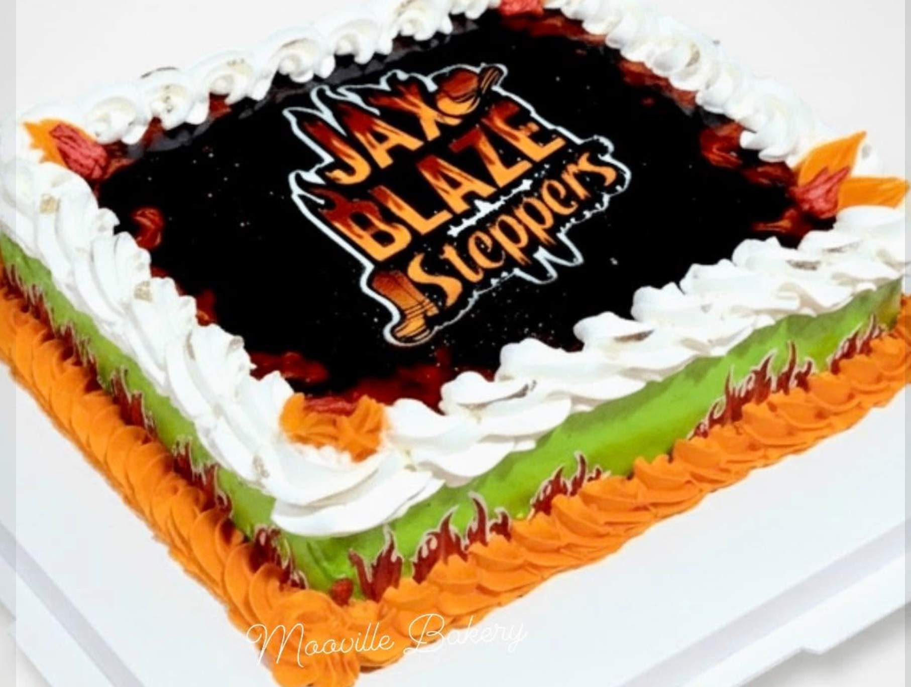 Custom Jax Blaze Steppers logo cake with flame piping by Mooville Bakery.