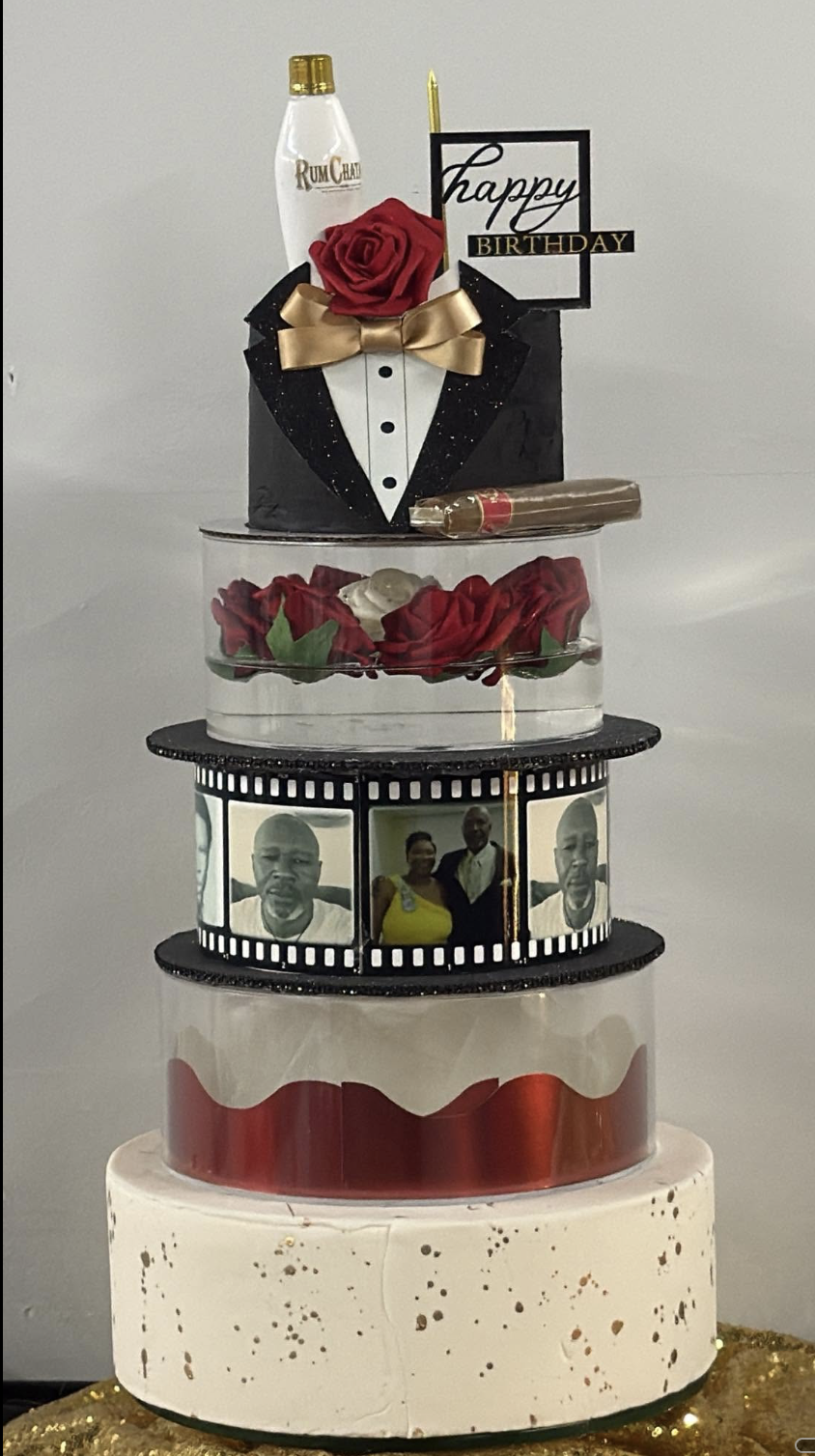 Tall tuxedo themed tiered birthday cake with red roses, photo film strip, and Rum Chata topper.